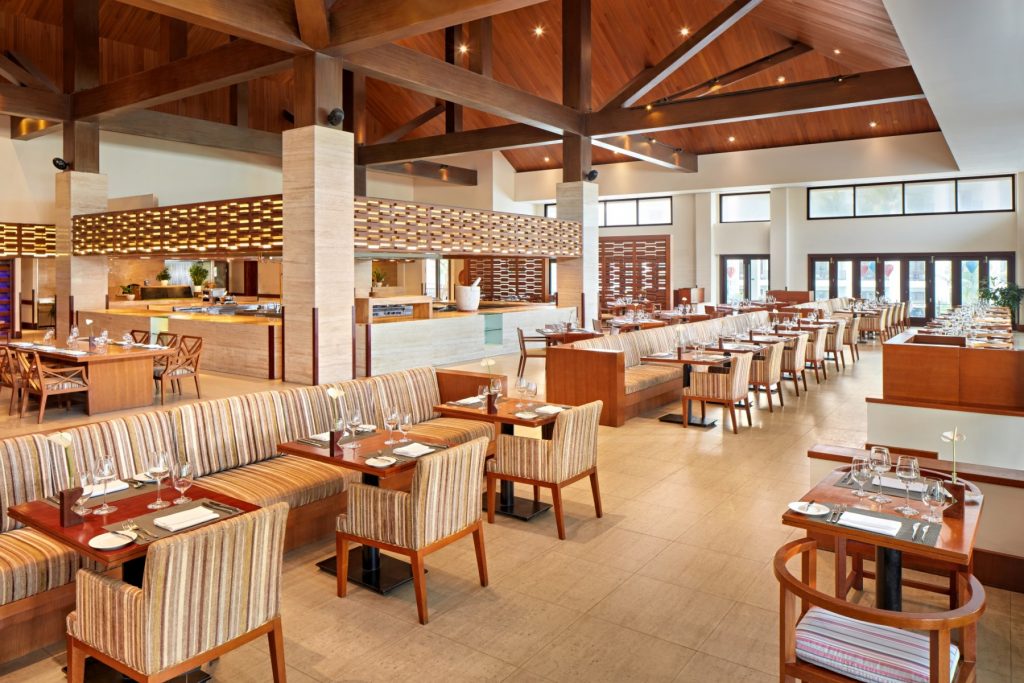 Epice Restaurant at Pullman Danang Beach Resort — elegant indoor dining with tropical garden views